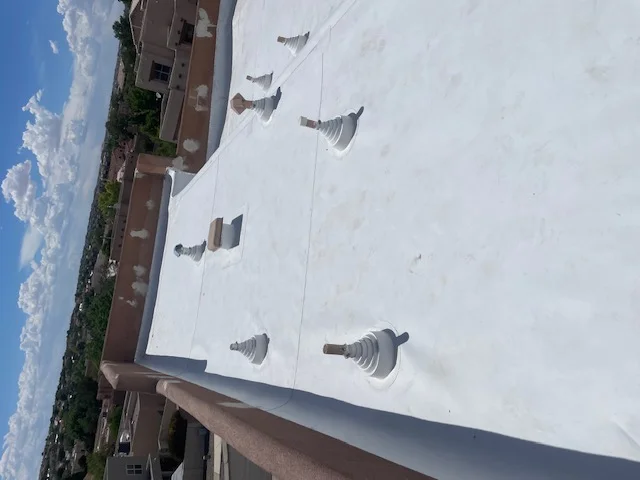 A roof covered with white plastic sheeting, providing protection and insulation from the elements.